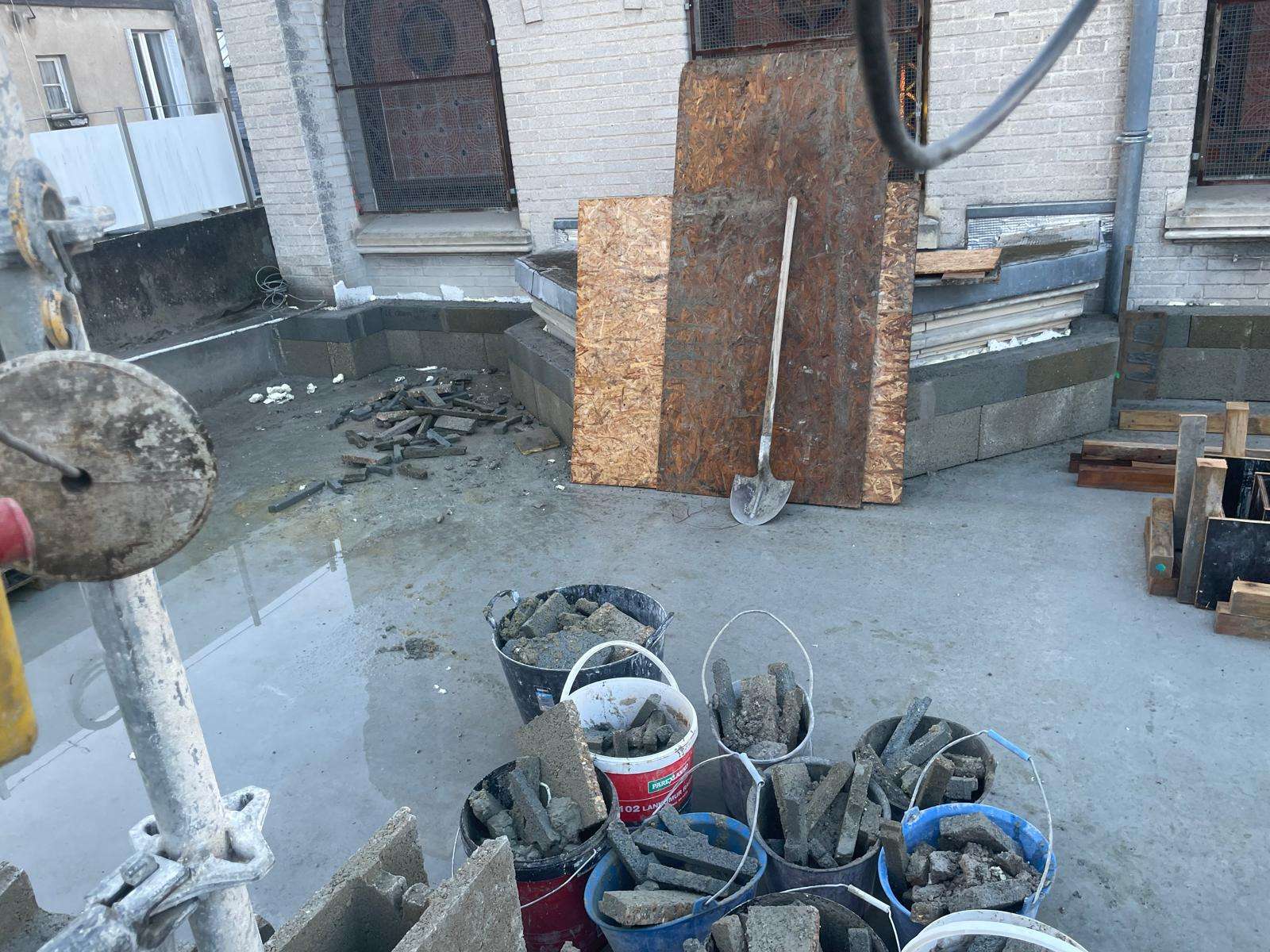 The excavation alongside the synagogue in Tours, France, with buckets of broken-out rubble