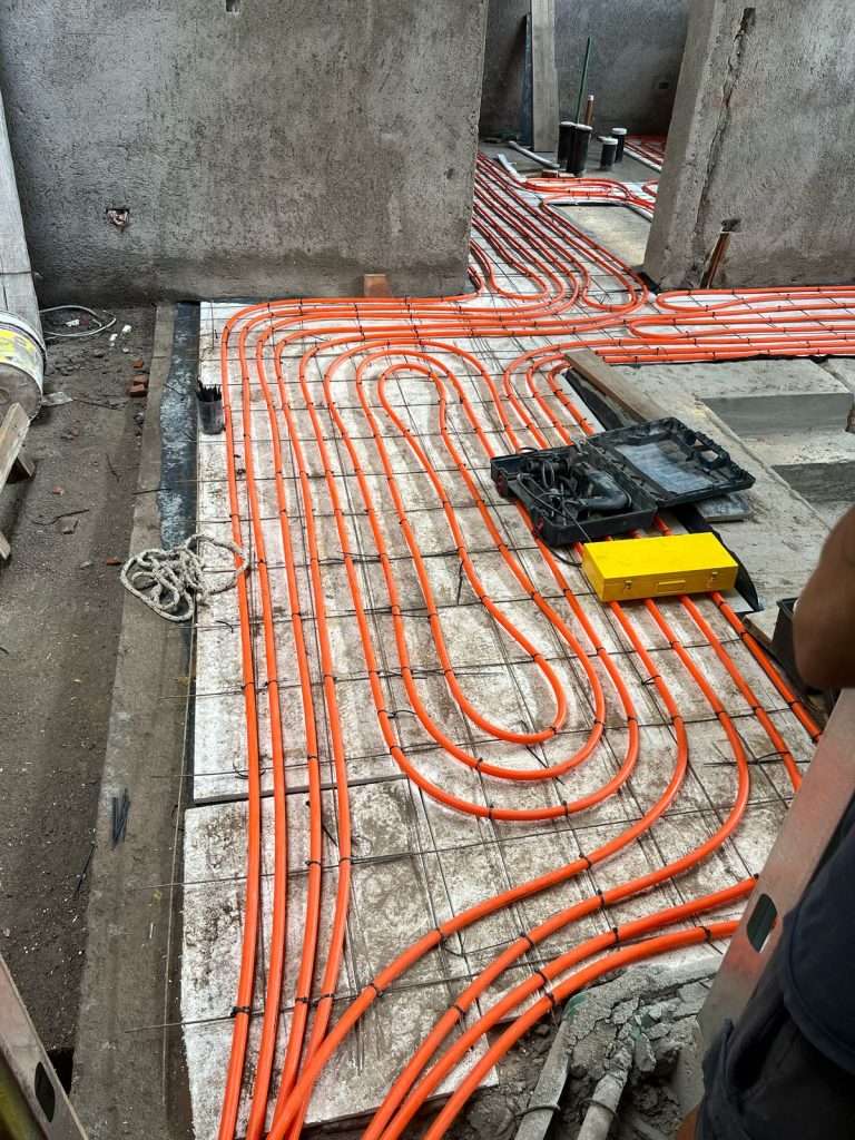 Underfloor heating pipes laid over the reinforcement before the slab pour in Cordoba, Argentina