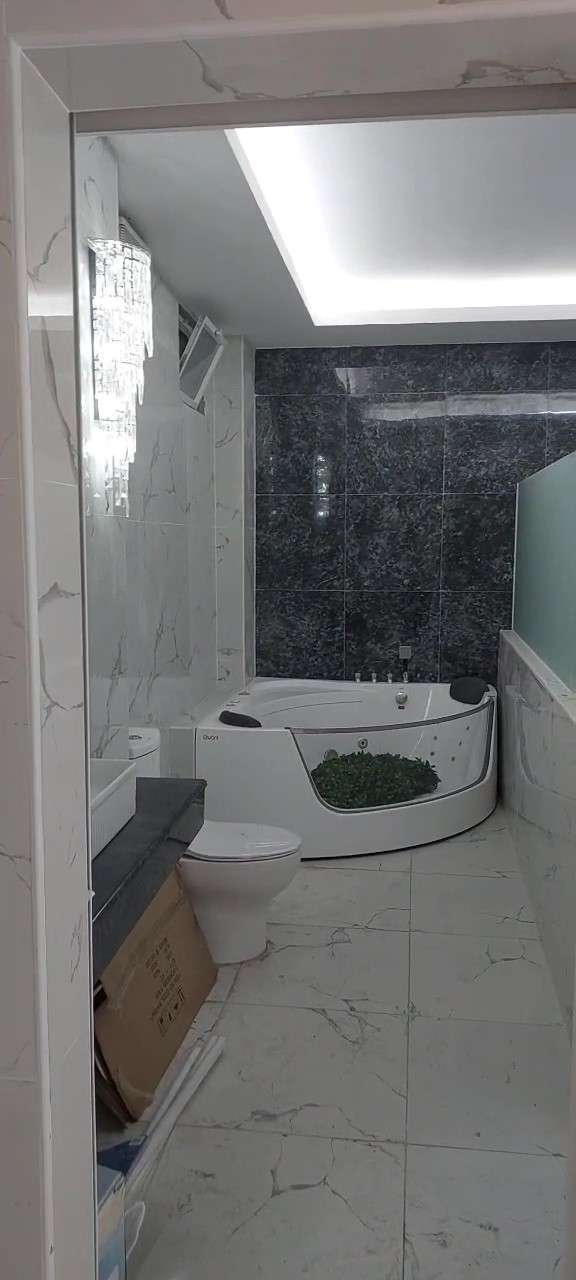 The finished preparation room at the Cebu mikvah, with a corner bath and marble tiling
